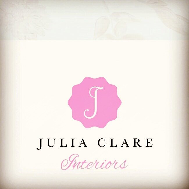 Julia Clare Interiors logo in pink on off white background.